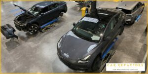 Vehicle refurbishment specialists working on electric cars at Car Refactory's modern workshop in France