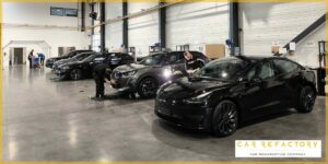 Car Refactory's industrial vehicle refurbishment facility with multiple vehicles undergoing professional reconditioning