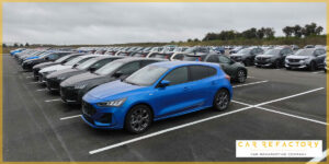 Rows of Peugeot vehicles awaiting vehicle refurbishment services at Car Refactory's secure storage facility