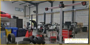 Professional vehicle refurbishment workshop with tire balancing machines and wheel service equipment at Car Refactory