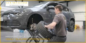 Car Refactory technician installing refurbished wheel as part of comprehensive vehicle refurbishment service